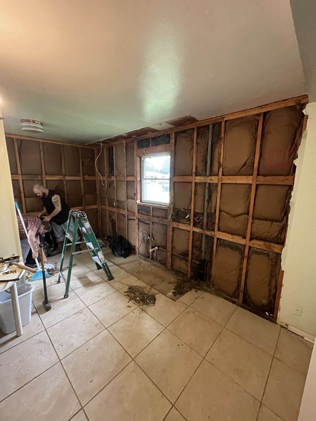 D&D Rustics project with damaged drywall removed down to the framing and insulation